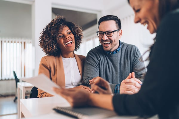 Married couple discussing checking products with banker