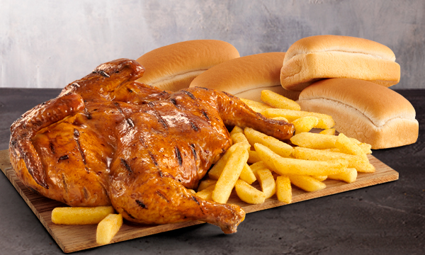 A Flame-Grilled full chicken with a large portion of Famous Hand-Cut Chips from Steers®  and 4 fresh mini loaves, against a purple and grey background.