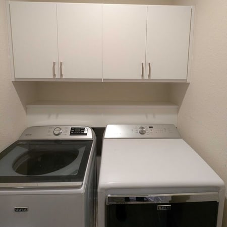 Virginia Beach - Laundry room - overhead cabinetry above washer and dryer units.