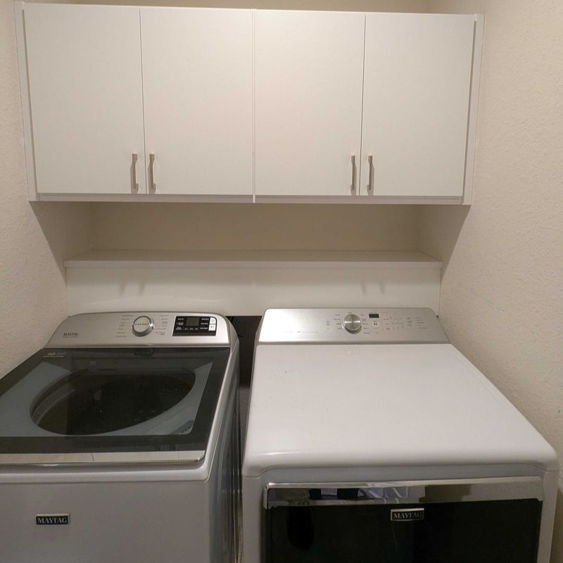 Virginia Beach - Laundry room - overhead cabinetry above washer and dryer units.