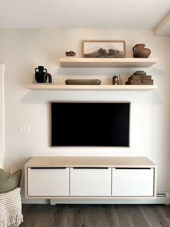 Floating media centre with floating shelves in a natural and white finish.