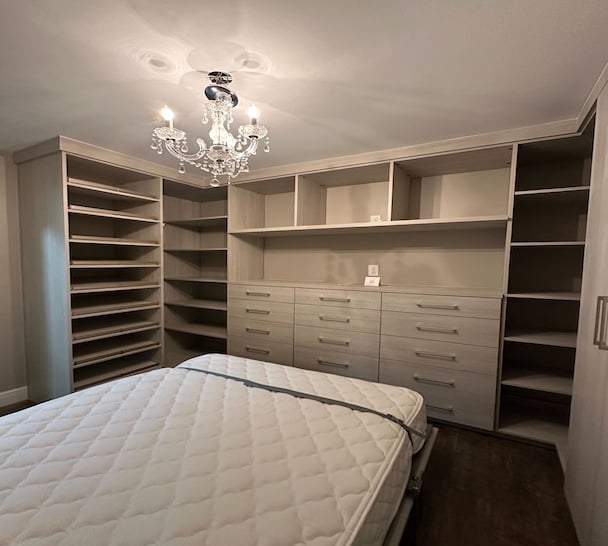 Wall bed with light wood shelving and drawers