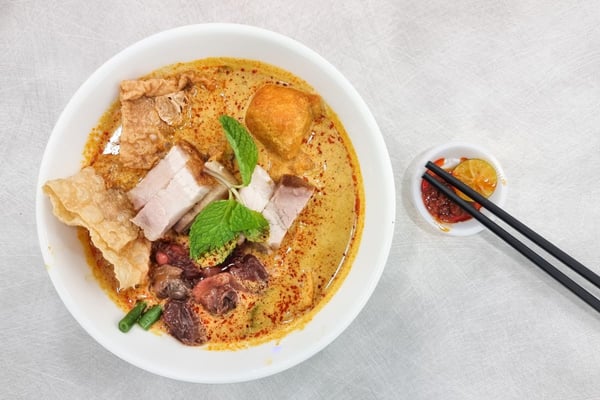 curry laksa with roast pork and fresh raw cockerel