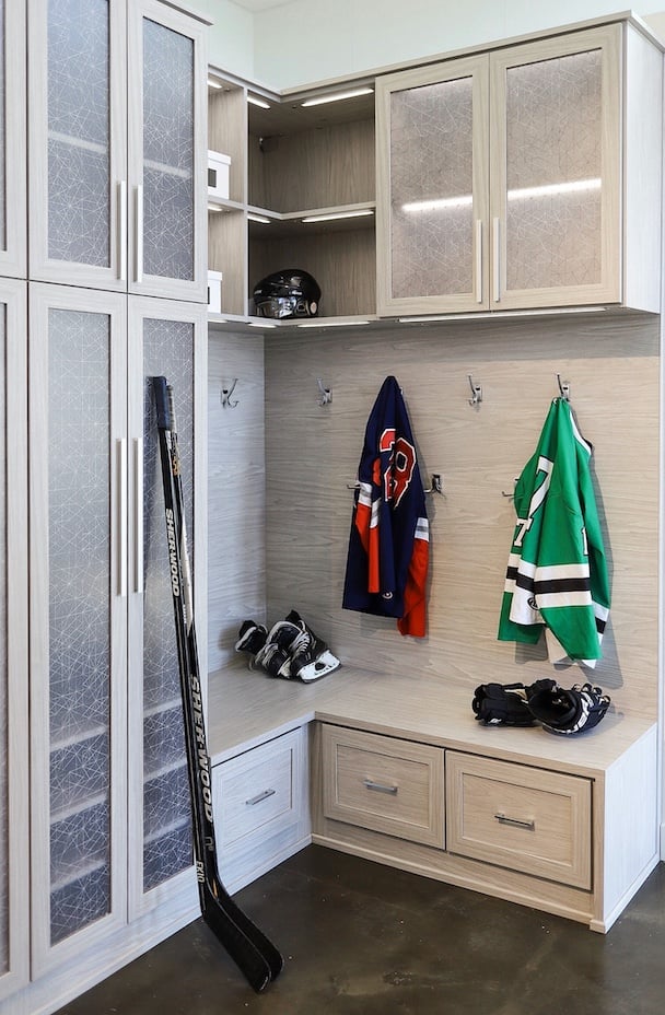 Custom mudroom storage with built-in bench, coat hooks, and upper cubbies.