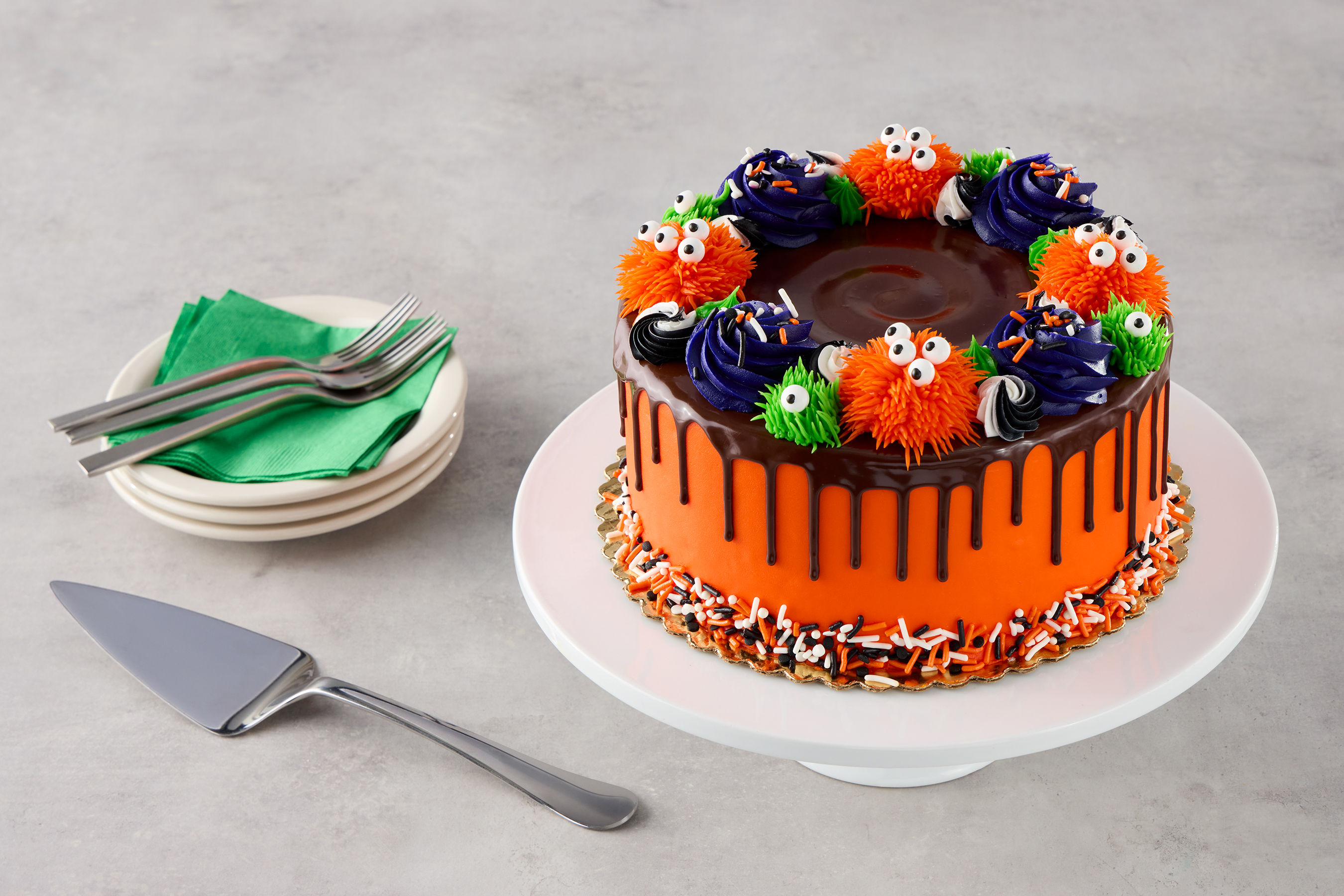 halloween decorated cake with orange and green monsters