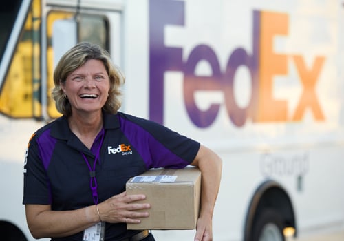 FedEx Ground employee holding a package