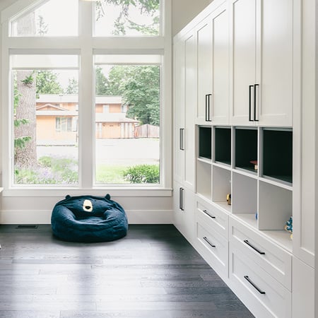 Custom closet design with shelves, drawers, and cabinets for workspace area by California Closets