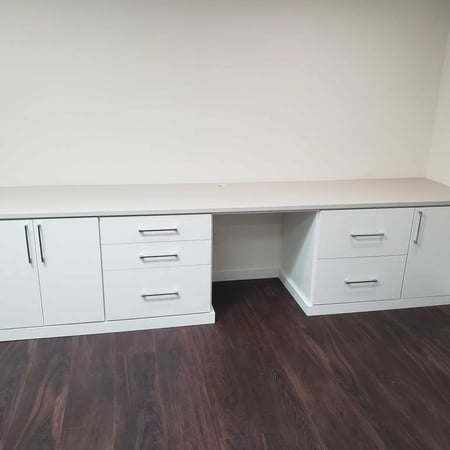 Greensboro - Custom closets - white desk with drawers and cabinets on each side against a neutral wall