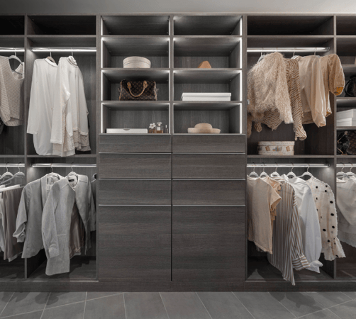 Dark Gray walk-in closet with drawers in the middle, tilt-out hampers, LED lighting, shelving and double hanging on either side Cold Spring New York Dutchess County NY
