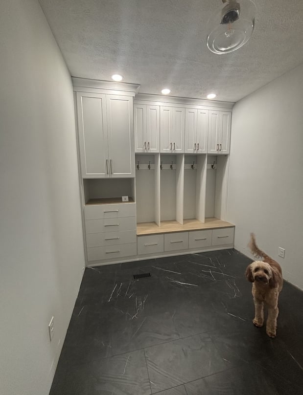 Custom mudroom storage with bench and overhead cabinetry.