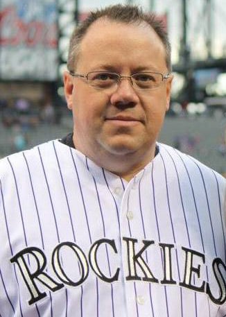 Retail owner Ted Phillips wearing a Colorado Rockies jersey while at a baseball game