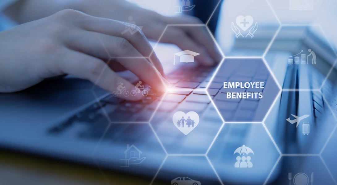 close up of hands typing on laptop overlaid with icons related to employee benefits
