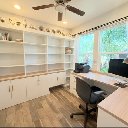 Custom office with washed white and Cassini cabinetry with gold elite handles.
