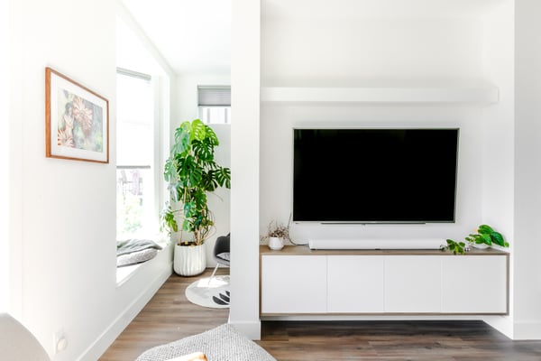 Hung television with built in storage underneath