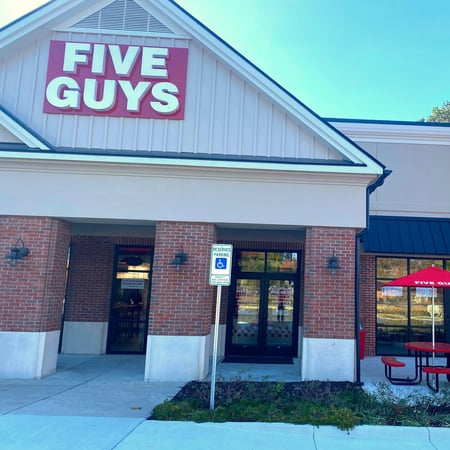 Exterior photograph of the entrance to the Five Guys restaurant at 70e England Street in Ashland, Virginia.
