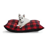 dog laying on red flannel bed