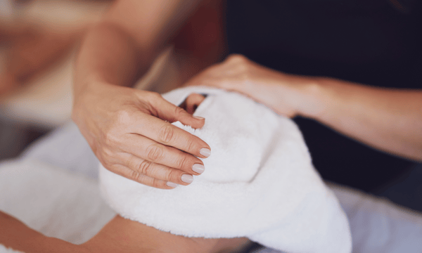 Man enjoying a relaxing hot towel facial, part of Dad’s Ultimate Retreat Package at our spa.
