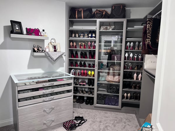 Walk in closet with shoe storage, jewelry storage, and shelving for purse by California Closets Cleveland, Ohio.