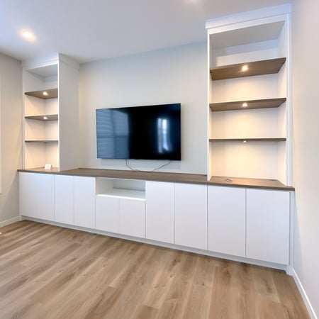 Media centre in a white finish with dark countertop and shelves.