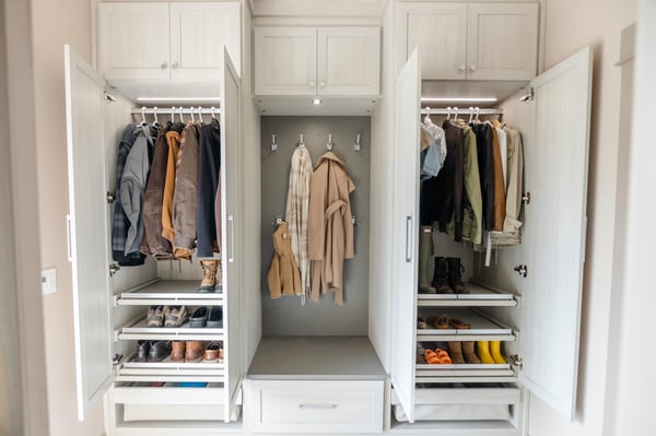 Custom mudroom designed in a light woodgrain finish with chrome hardware, pull out shelves and a bench. Add contrasting colors to fit your personal design style.