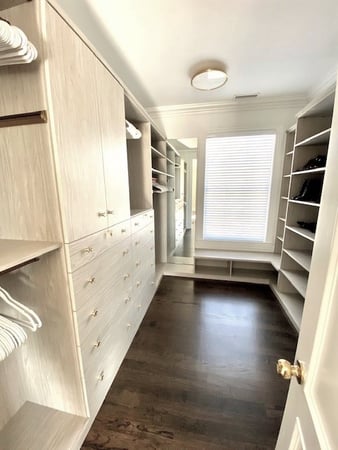 Walk-in closet california closets new york beige white closet shelves closed cabinet doors drawers, double hanging