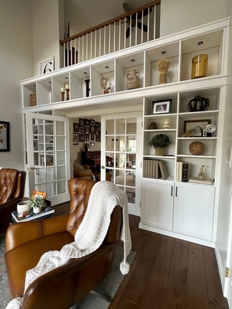 Living room storage with built in shelving and integrated lighting by California Closets Albany, New York.