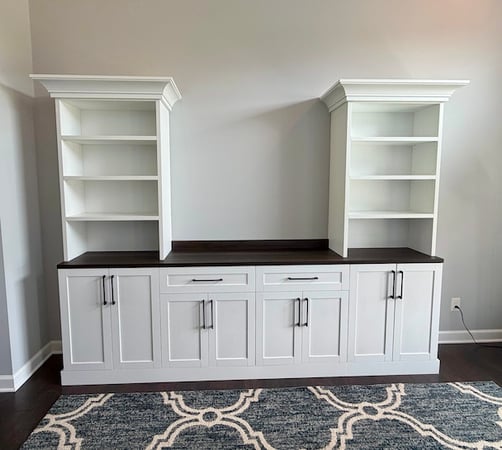 Built-in bookshelf with cabinets and custom wall unit design featuring open shelving, concealed storage, and display space. This living room storage solution combines custom cabinets and practical storage solutions for an organized, polished look. South Lyon, Michigan