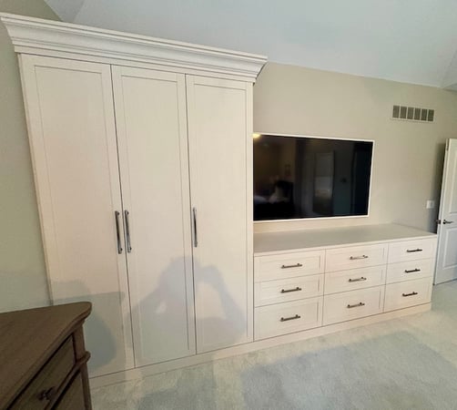 Wardrobe cabinets and custom closet systems with concealed storage, drawers, and built-in organization. This bedroom storage solution combines custom closets and functional closet organization to maximize space and reduce clutter. Northville, Michigan