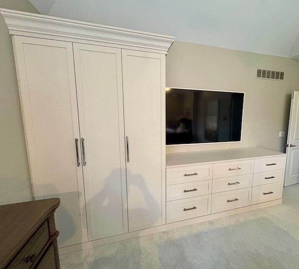 Wardrobe cabinets and custom closet systems with concealed storage, drawers, and built-in organization. This bedroom storage solution combines custom closets and functional closet organization to maximize space and reduce clutter. Northville, Michigan