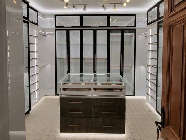 Walk-in closet with center island and glass doors by California Closets Baldwin County & Mobile, Alabama.