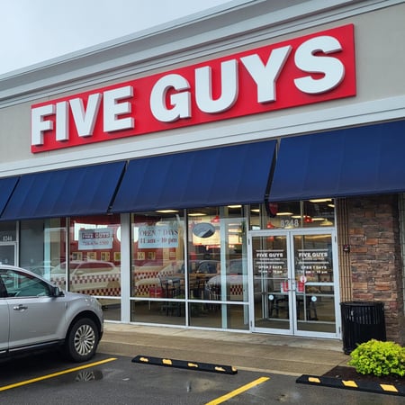 Exterior photograph of the Five Guys restaurant at 8248 Transit Road in Amherst, New York.