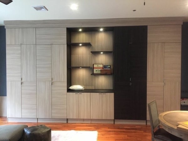 Custom Storage Unit with Staggered Shelving and Accent Lighting