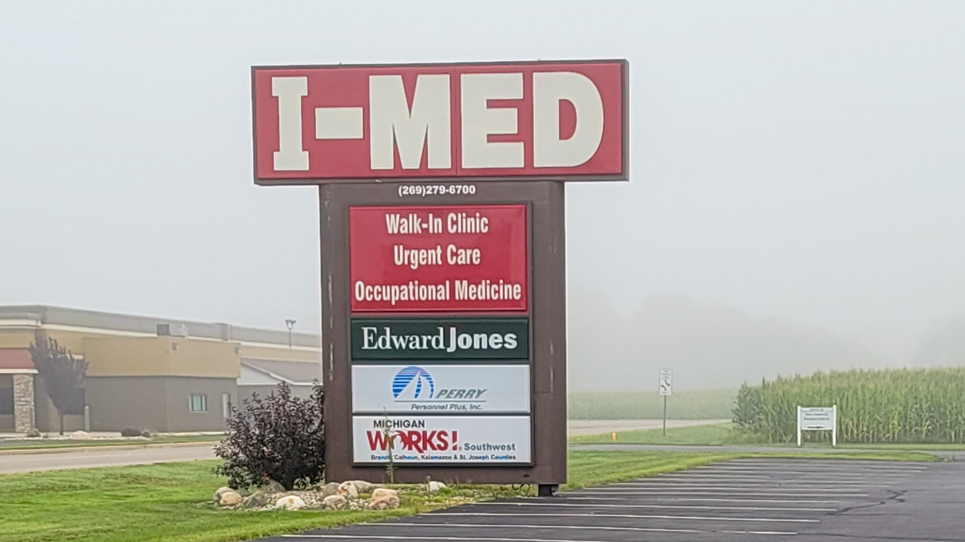 A large red sign says "I-MED: walk-in clinic, urgent care, and occupational medicine"