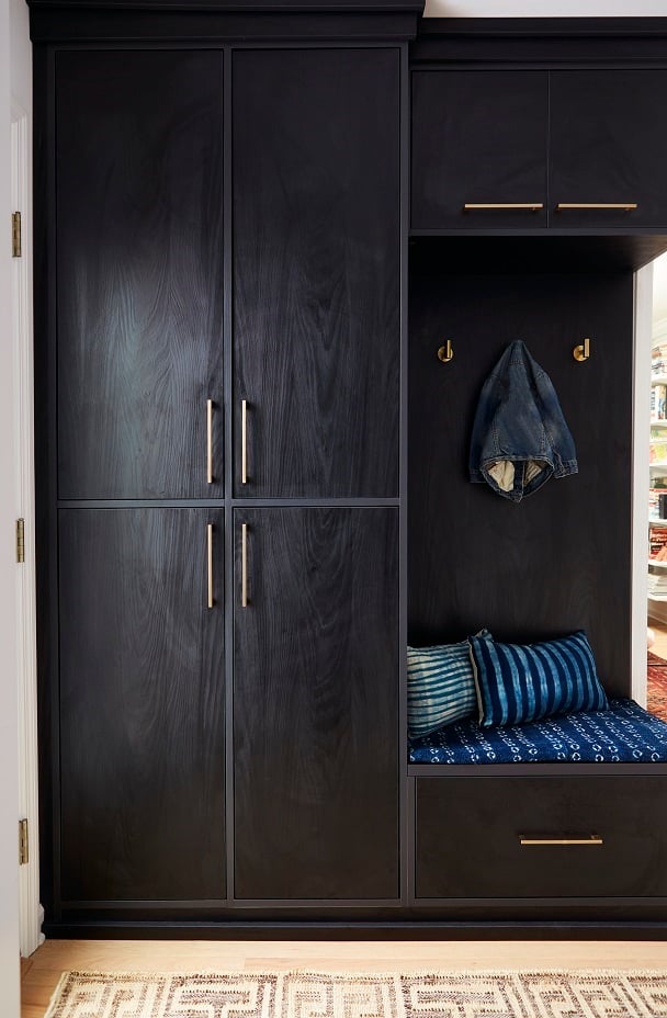 Custom mudroom storage with cabinets, bench, and hooks for practical entryway storage solutions