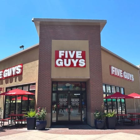 Exterior photograph of the Five Guys restaurant at 180 Paseo del Centro in Fresno, California.