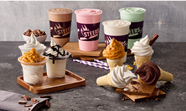 Various Steers® ice cream desserts on a granite surface. From milkshakes to ice cream cones and ice cream swirls in a cup.