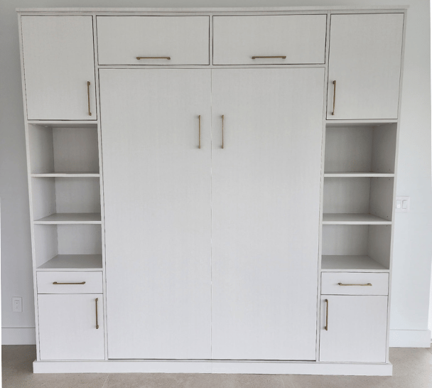 Custom white wall bed in Boca Raton, FL with elegant gold hardware and integrated storage by California Closets
