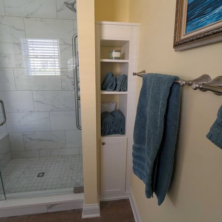 Richmond - Custom closets - bathroom storage with open shelving and a closed cabinet beside a walk-in shower