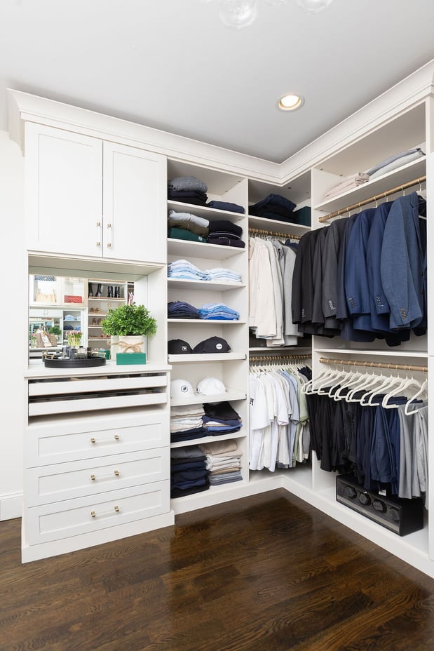 Custom white men's walk-in closet with pull-out shelves, double hanging and drawers.