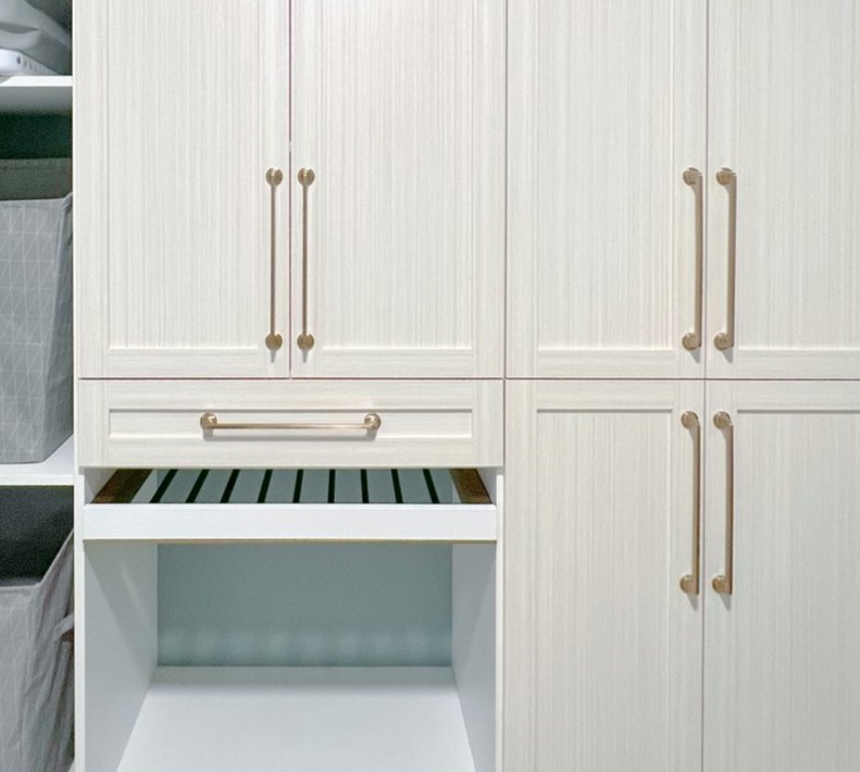 A close-up of a drying rack in a clean, light laundry room