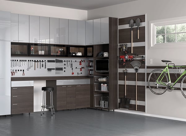 Garage storage with cabinets, drawers, workbench, and tool rack by California Closets Northern Michigan