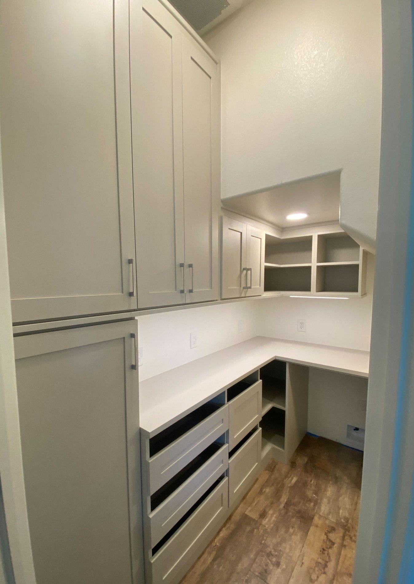 Morning Light Walk-in pantry with open countertop and large drawers for organizing pantry goods.  Features shaker style cabinetry.