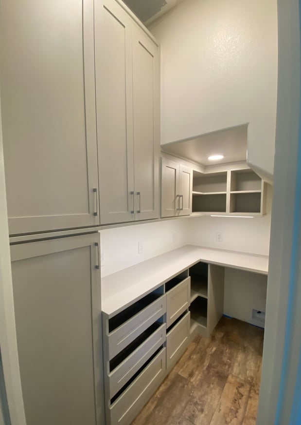 Morning Light Walk-in pantry with open countertop and large drawers for organizing pantry goods.  Features shaker style cabinetry.