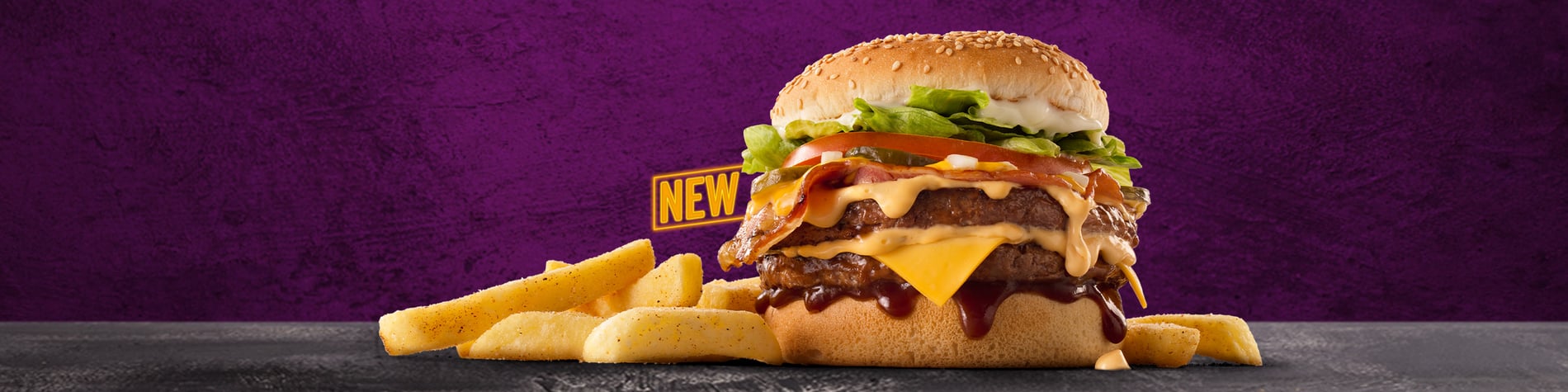 Got Cheese King Steer® Burger Meal with a cheeseburger and chips against a purple background.