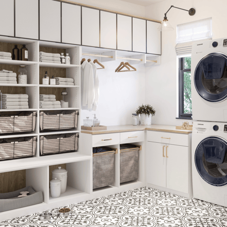 Light laundry room with shelves, baskets, countertop, and cabinets.