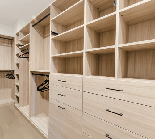 California Closets New York NY Walk-in Closet with Various Storage Options with Drawers, Cubby-like Shelving, Double Hanging and Black Hardware