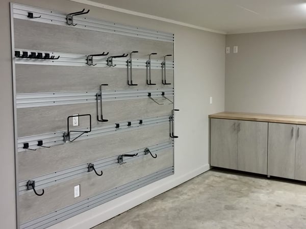 Custom storage in garage fusion track wall system garage organization by California Closets Baton Rouge, Louisiana.