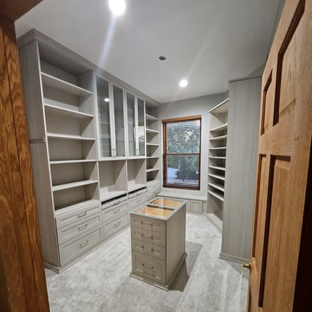 Grey dressing room with custom island and glass countertop
