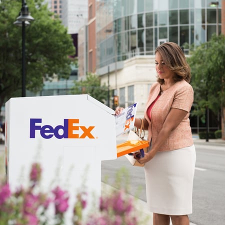 Women dropping off at FedEx drop box