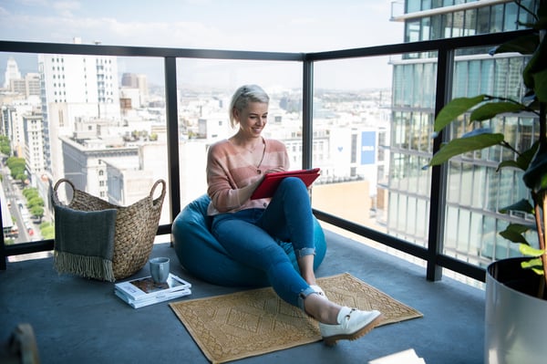 Woman on balcony streaming a movie